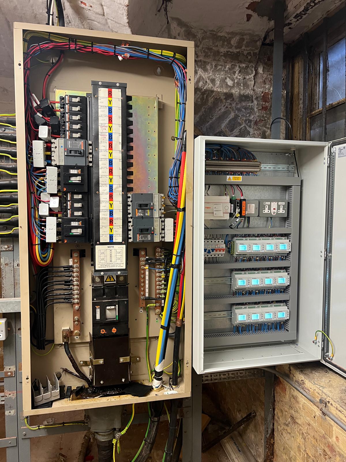 School distribution board beside completed energy monitoring cabinet